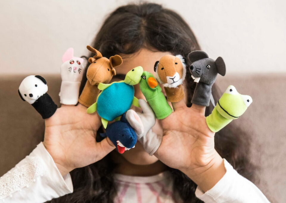 https://www.littlepassports.com/wp-content/uploads/2022/09/Young-child-covering-face-wearing-animal-puppets-on-fingers-little-passports-960x681.jpg